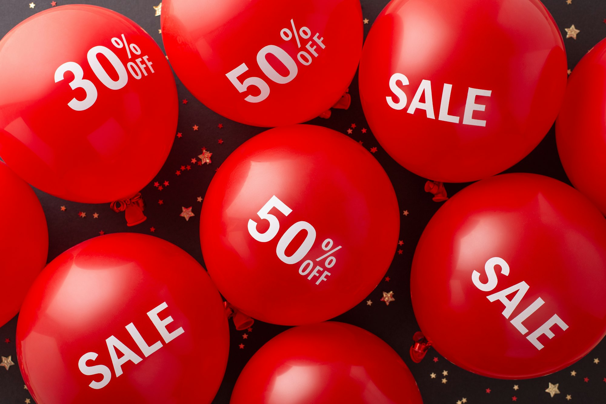 Frugal consumer Black Friday presentation. Top view of red balloons showcasing "discount"